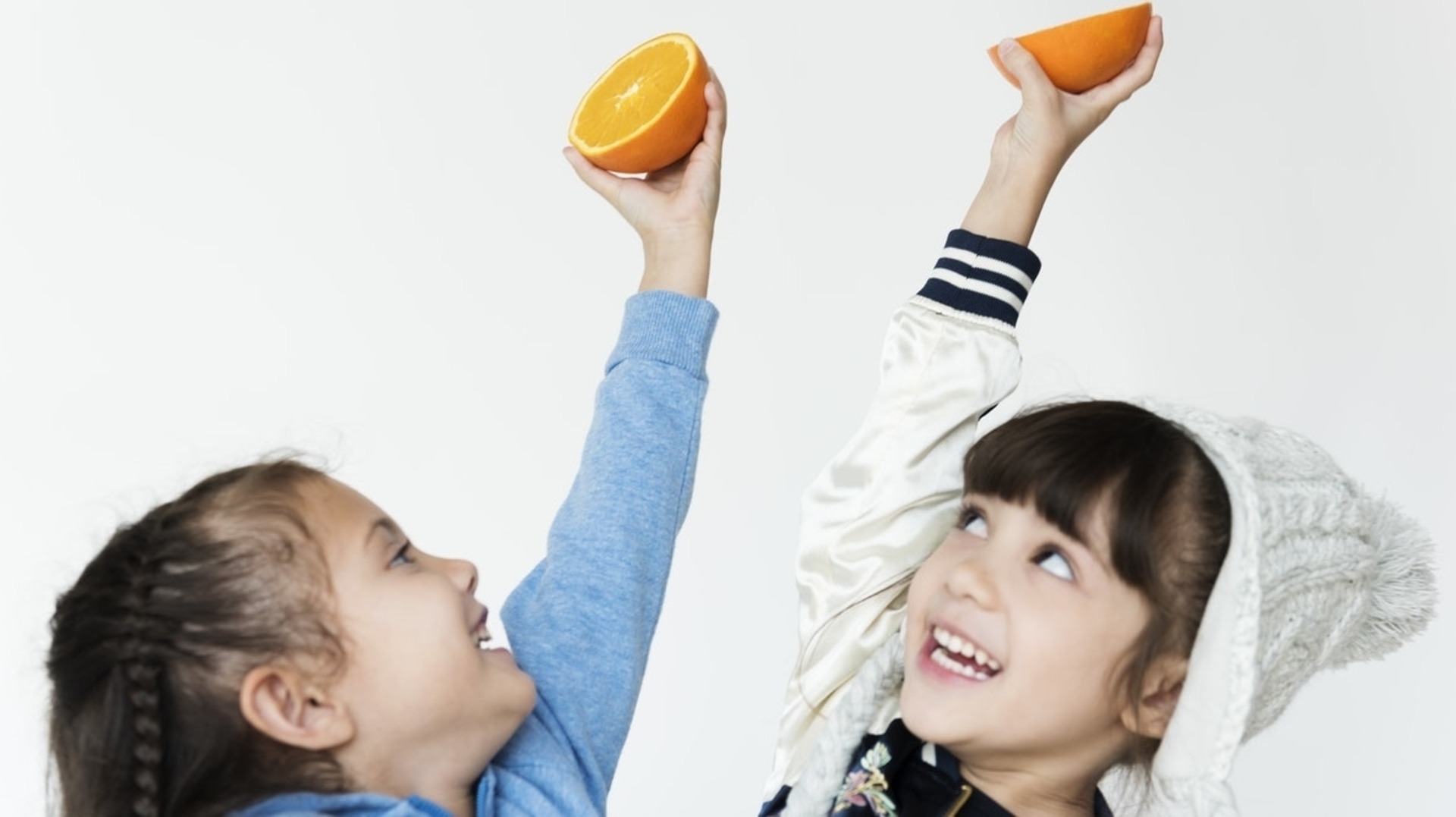 kids holding oranges